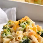 Chicken broccoli casserole with golden Panko cheddar topping fresh from the oven in a white casserole dish