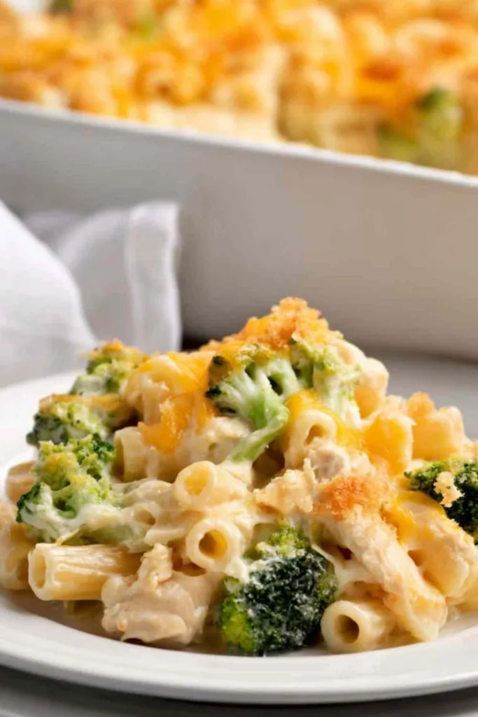 Chicken broccoli casserole with golden Panko cheddar topping fresh from the oven in a white casserole dish