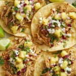 Chipotle chicken tacos topped with fresh pineapple salsa on warm corn tortillas