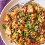 Crockpot teriyaki chicken and rice with pineapple chunks and sesame seeds in a slow cooker