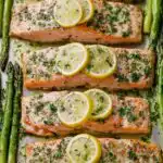 Sheet pan salmon and asparagus with lemon caper butter on a rimmed baking sheet
